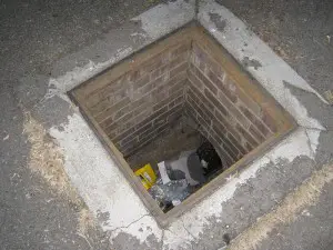 A manhole that has a missing, presumably stolen, cover.